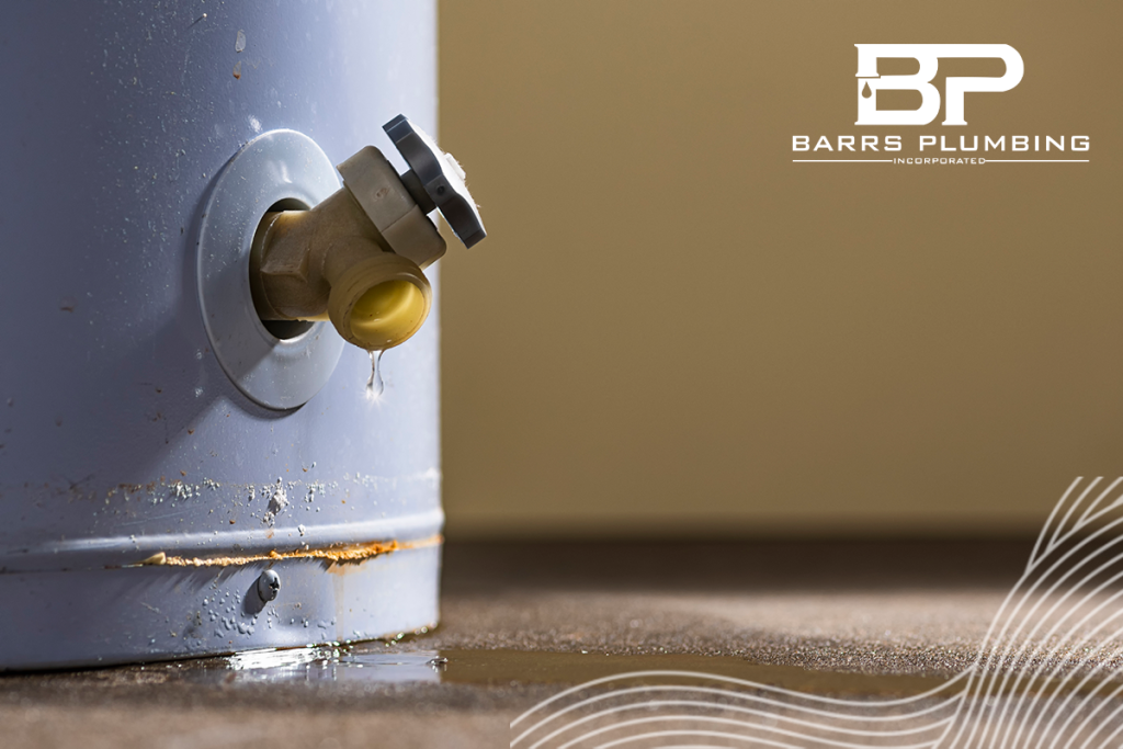 A low angle close-up view of water leaking from the plastic faucet on a residential electric water heater sitting on a concrete floor in the basement.