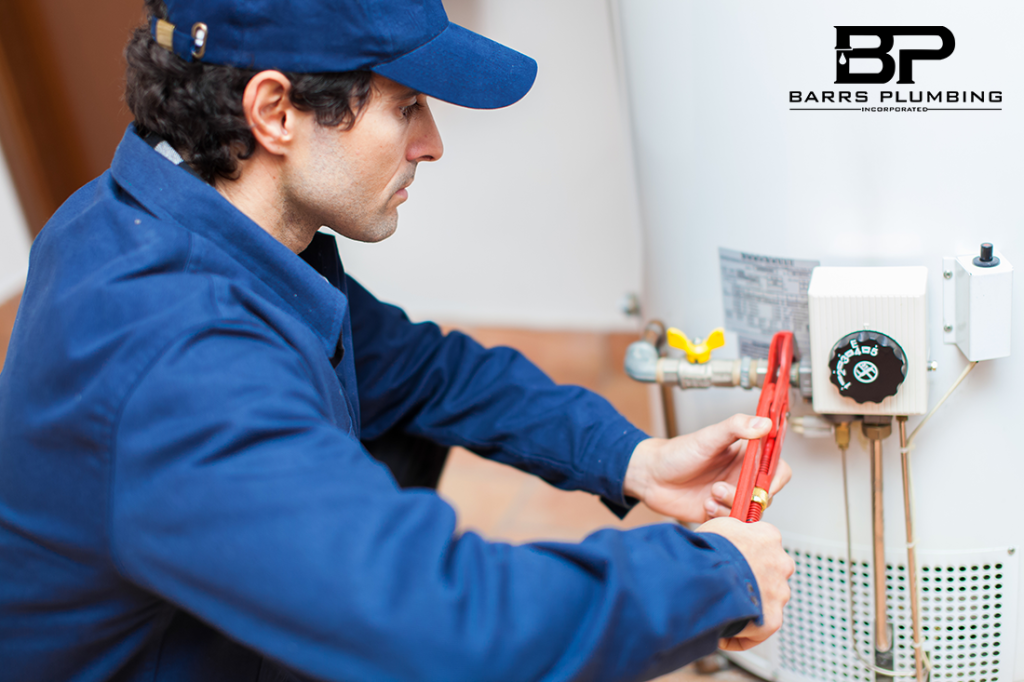 Plumber fixing an hot-water heater